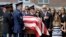FILE - Vice President Joe Biden, accompanied by his family, watches an honor guard carry a casket containing the remains of his son Beau Biden into a funeral service at St. Anthony of Padua Roman Catholic Church in Wilmington, Del., June 6, 2015. 