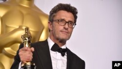 Pawel Pawlikowski poses in the press room with the award for best foreign language film for “Ida” at the Oscars, Feb. 22, 2015, at the Dolby Theatre in Los Angeles. 