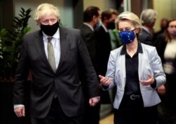 FILE - European Commission President Ursula von der Leyen welcomes British Prime Minister Boris Johnson in Brussels, Belgium, Dec. 9, 2020.