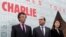 Presiden Perancis Francois Hollande (tengah) didampingi Menteri Kebudayaan Fleur Pellerin (kanan) dan Presiden Arab Institut 'Institut du Monde Arabe', Jack Lang (kiri) melewati dinding bertuliskan "We are Charlie" di kampus institusi pendidikan tersebut di Paris (15/1).