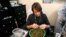 Skylar Hall prepares marijuana buds for sale at the Botana Care store ahead of their grand opening on New Year's day in Northglenn, Colorado, Dec. 31, 2013.