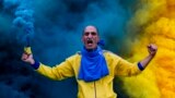 An Estoril Praia soccer team fan cheers for his team in the beginning of a Portuguese First League Soccer match at António Coimbra da Mota Stadium, Estoril, Portugal.