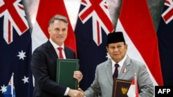 Indonesia's Defense Minister and President-elect Prabowo Subianto, right, and Australia's Deputy Prime Minister and Defense Minister Richard Marles shake hands after signing the Australia-Indonesia Defense Cooperation Agreement Aug. 29, 2024.