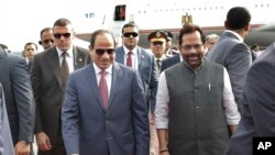 Egyptian President Abdel-Fattah el-Sissi, center left is received by Indian Junior Minister for Minority Affairs and Parliamentary Affairs Mukhtar Abbas Naqvi, right upon arrival at the airport in New Delhi, India, Thursday, Sept.1, 2016.