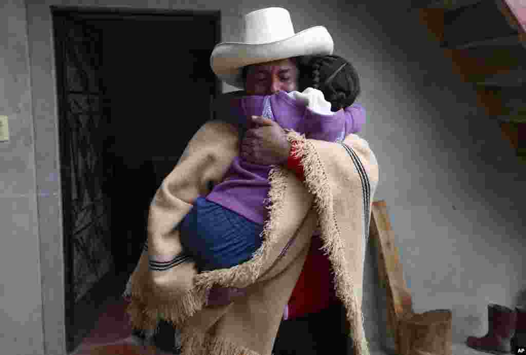 Free Peru party presidential candidate Pedro Castillo hugs his daughter Alondra who cries before he leave home, as he prepares to campaign in Chugur.