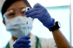 A medical worker fills a syringe with a dose of the Pfizer-BioNTech coronavirus disease (COVID-19) vaccine as Japan launches its inoculation campaign, at Tokyo Medical Center in Tokyo, Feb. 17, 2021.