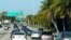 FILE - Cars slow down after crossing a causeway to Miami Beach, Florida, May 28, 2021.