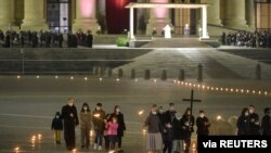 Pope Francis officiates at the Via Crucis (Way of the Cross) procession in a near empty square outside Saint Peter's Basilica during Good Friday observances at the Vatican, April 2, 2021. (Vatican Media/Handout via Reuters) 