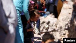 A daughter of one of two victims of the deadly earthquake reacts during their funeral, in Moulay Brahim, Morocco, September 10, 2023. 