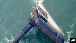 FILE - The capsized lift boat Seacor Power is about 7 miles off the coast of Louisiana in the Gulf of Mexico, April 18, 2021.