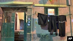 The ground floor apartment of Ahmed Shaban, whose death is linked to police at an Alexandria police station, is distinguished by the black mourning clothes hanging outside, 22 Nov 2010