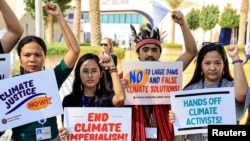 Activists hold placards and shout slogans during a protest at the United Nations climate summit COP28 in Dubai, United Arab Emirates, on Dec. 6, 2023.