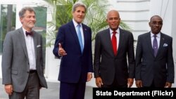 U.S. Secretary of State John Kerry poses for a photo with U.S. Ambassador to Haiti Peter Mulrean, Haitian President Michel Martelly, and Haitian Prime Minister Evans Paul before their meeting at the Presidential Palace in Port-au-Prince, Haiti, on Oct. 6, 2015.