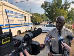 FILE - Shelby County Sheriff’s Office spokesman Anthony Buckner talks to reporters about a shooting in which two deputies were injured and a suspect was fatally shot, Sept. 18, 2019, in Memphis, Tenn. Homicides in the city are up nearly 50% in 2020.