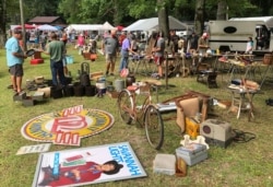 A crowd looks through items at the World's Longest Yard Sale, which stretches from Alabama to Michigan, at its southernmost point in Gadsden, Ala., on Aug. 6, 2020.