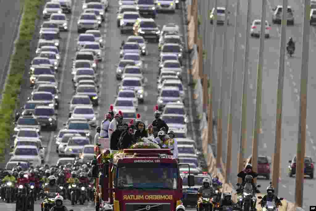 Relatives and artists accompany the coffin containing the remains of Brazilian singer Marilia Mendonca, in a funeral procession through the streets of Goiania, Brazil, Saturday, Nov. 6, 2021.