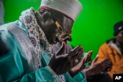 FILE—Imam Omar Niass leads evening prayers with mostly Senegalese migrants, March 15, 2024, at Bronx's Masjid Ansaru-Deen mosque in New York.