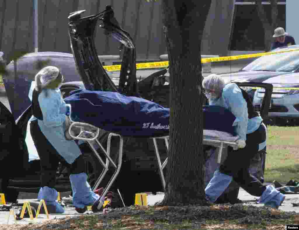 The bodies of two gunmen are moved away from a car during an investigation by the FBI and local police in Garland, Texas May 4, 2015.