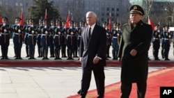 U.S. Secretary of Defense Robert Gates, left, participates in an arrival ceremony with China's Minister of National Defense Gen. Liang Guanglie, right, at Bayi Building in Beijing, China, on Monday January 10, 2011