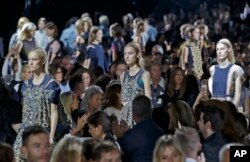 Models wear creations for Sacai's Spring-Summer 2016 ready-to-wear fashion collection presented in Paris, France, Oct. 5, 2015.