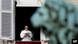 Pope Francis reads the list of 19 new Cardinals during the Angelus prayer in St. Peter's Square, at the Vatican, Jan. 12, 2014