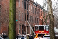 Philadelphia firefighters work at the scene of a deadly row house fire, Jan. 5, 2022, in the Fairmount neighborhood of Philadelphia.