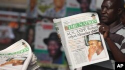 An Unidentified man reads a newspaper with headline Electoral Commission Chairman Attahiru Jega Apologies for elections postponement, published in Lagos, Nigeria, Sunday, April 3, 2011. Nigeria postponed its National Assembly elections Saturday as ballot