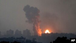Fire and smoke rise following an Israeli airstrike in the Gaza Strip, as seen from southern Israel, Oct. 28, 2023.