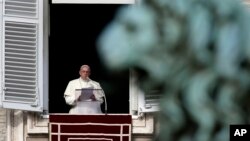 Pope Francis reads the list of 19 new Cardinals during the Angelus prayer in St. Peter's Square, at the Vatican, Jan. 12, 2014