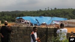 People gathered at the site of a collapsed church in Uyo, Nigeria, Dec. 11, 2016.