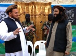 FILE - Tehreek-e-Taliban Pakistan (TTP) spokesman Ehsanullah Ehsan (L) talks with new TTP member Adnan Rasheed following a press conference in Shabtoi, a village in Pakistan's South Waziristan, Feb. 2, 2013.