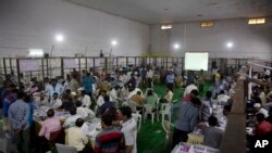 Indian election officials count votes of the Telangana state assembly elections at a counting center in Hyderabad, India, Dec. 11, 2018.