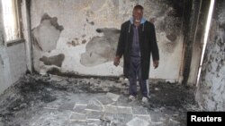 A man inspects his house that was damaged during recent clashes between armed factions in Tripoli's Abu Selem district, Libya, March 1, 2017. 