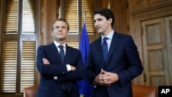 French President Emmanuel Macron and Canadian Prime Minister Justin Trudeau wait for the start of a photo opportunity in Trudeau's office on Parliament Hill in Ottawa, Ontario, Canada, June 6, 2018.