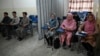 Students attend a class bifurcated by a curtain separating males and females at a private university in Kabul, Afghanistan, Sept. 7, 2021, to follow the Taliban's ruling.