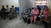 Students attend a class bifurcated by a curtain separating males and females at a private university in Kabul, Afghanistan, Sept. 7, 2021, to follow the Taliban's ruling.