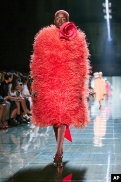 This Sept. 12, 2018 file photo shows a model wearing a coral outfit from the Marc Jacobs spring 2019 collection during Fashion Week in New York. (AP Photo/Kevin Hagen)