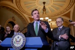 FILE - Senator Mark Warner, D-Va., speaks during a news conference on Capitol Hill in Washington, Feb. 15, 2017.