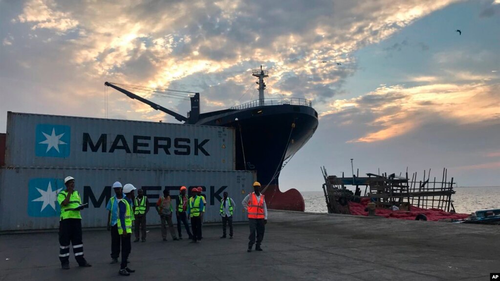 Workers stand in front of shipping containers at the Port of Berbera, run by DP World, which is majority-owned by the Dubai government in the UAE, in Berbera, Somaliland, Somalia, April 1, 2018.