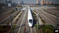 中国高速动车试行从北京开往上海。中国铁道部的负债增长超过资产增长（2011年6月27日）