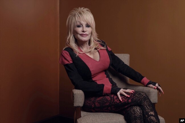 FILE - Dolly Parton poses for a picture before the Carnegie Medal of Philanthropy Ceremony at Gotham Hall on Thursday, Oct. 13, 2022, in New York. (AP Photo/Andres Kudacki)