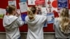 Students fill out registration forms as they take advantage of early voting in the 2024 election at a the University of Wisconsin in Madison, Wisconsin on October 22, 2024. Voters are making choices in local races and who they want to be the next US pre