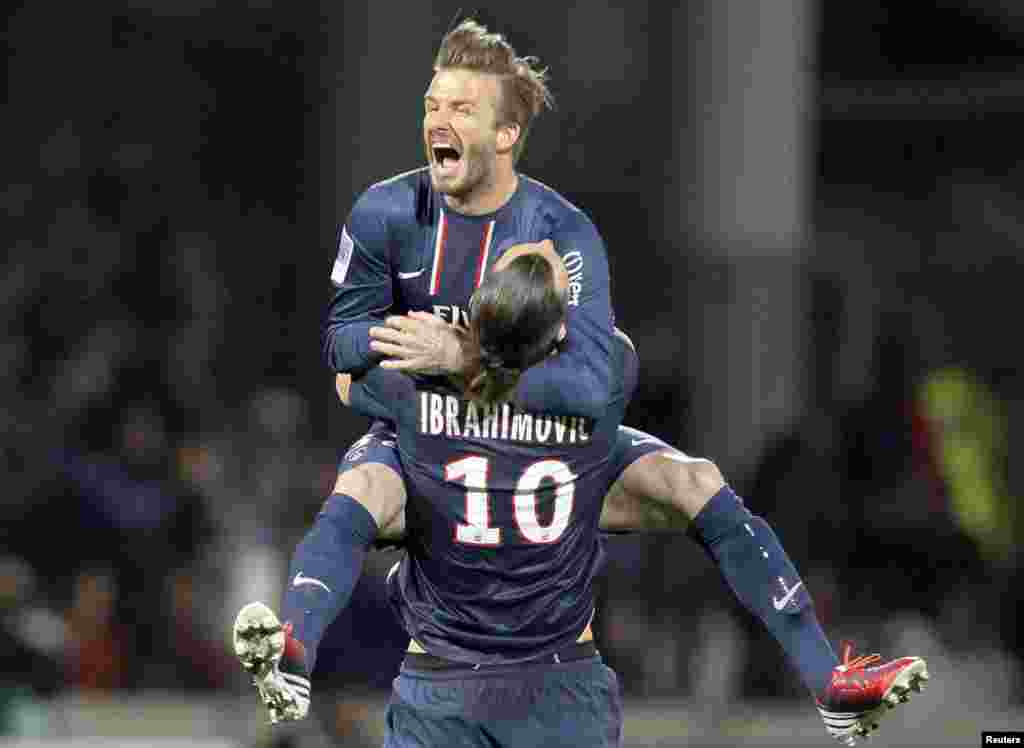 Zlatan Ibrahimovic e David Beckham do Paris Saint-Germain celebram no final da partida da primeira divisão da Liga Francesa contra o Olympique Lyon em Lyon (12 Maio de 2013)