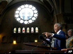 Rev. Al Sharpton stands with clergy and responds to a question during a news conference, July 13, 2017, in Chicago, where concerns were voiced over the announcement that more federal agents will be sent to Chicago without serious meetings with community leaders.