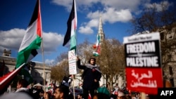 FILE—Pro-Palestinian activists and supporters hold placards and wave flags as they gather for a protest in Trafalgar Square in central London on March 30, 2024, calling for a ceasefire in the Israel/Hamas conflict.