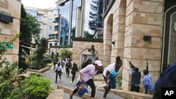 FILE - Civilians flee as security forces take aim at a hotel complex attacked by al-Shabab, in Nairob on Jan. 15, 2019. Facebook has failed to catch Islamic State group and al-Shabab extremist content in posts aimed at East Africa, according to a study released June 15, 2022.