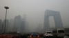 FILE - Cars travel on a road amid heavy haze in Beijing, Feb. 21, 2014. 