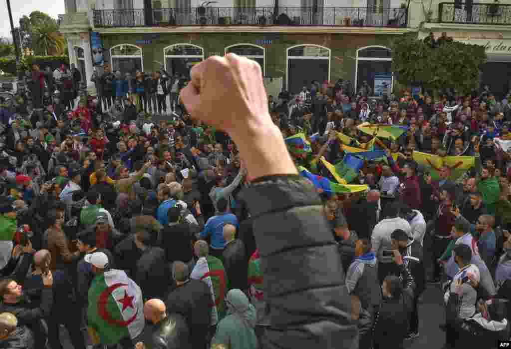 Algerian students raising Amazigh (Berber) and national flags shout slogans during their weekly anti-government demonstration in the capital Algiers.