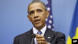 President Barack Obama gestures during his joint news conference with Swedish Prime Minister Fredrik Reinfeldt, Sept. 4, 2013, at the Rosenbad Building in Stockholm, Sweden.