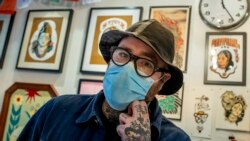 Owner and artist, Roman Castelvechi poses for a photo in his tattoo store in Brussels, on March 4, 2021. (AP Photo/Olivier Matthys, File)